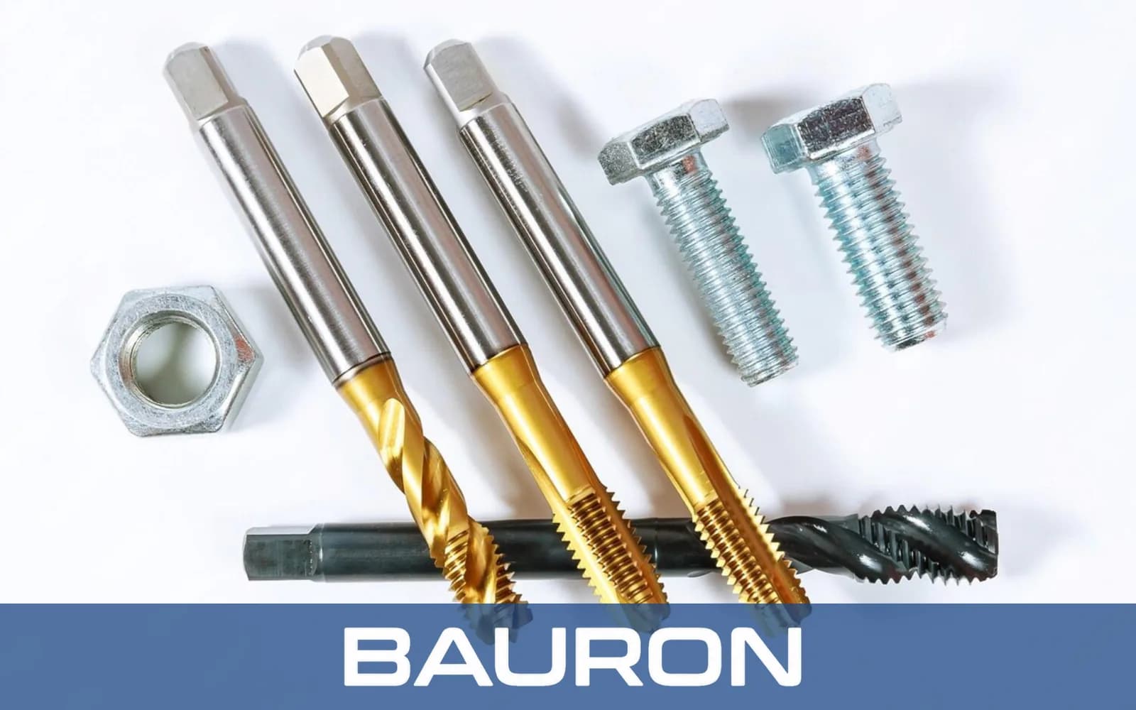 Tarauds revêtus TiN à côté de boulons filetés et d'un écrou hexagonal